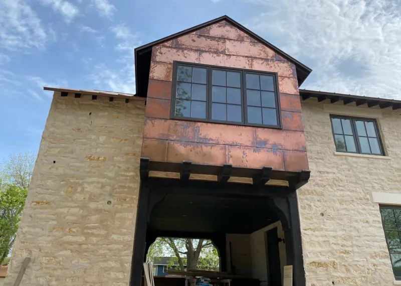 Copper metal panel facade on a stone building for Metal Roof Coating in La Porte
