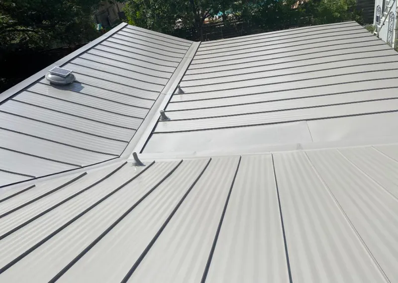 Solar attic fan installed on a metal roof for Roof Ventilation in La Porte